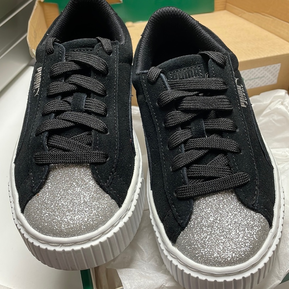 Puma black suede platform sneakers with a silver toe.